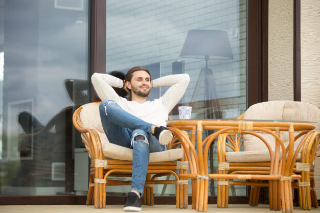 smiling-relaxed-man-enjoying-pleasant-morning-sitting-terrace-outdoor